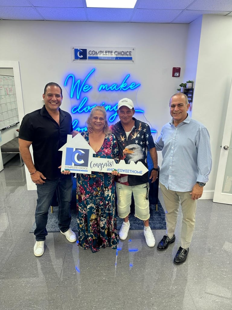 Four people holding a Complete Choice award plaque in an office with blue neon signage